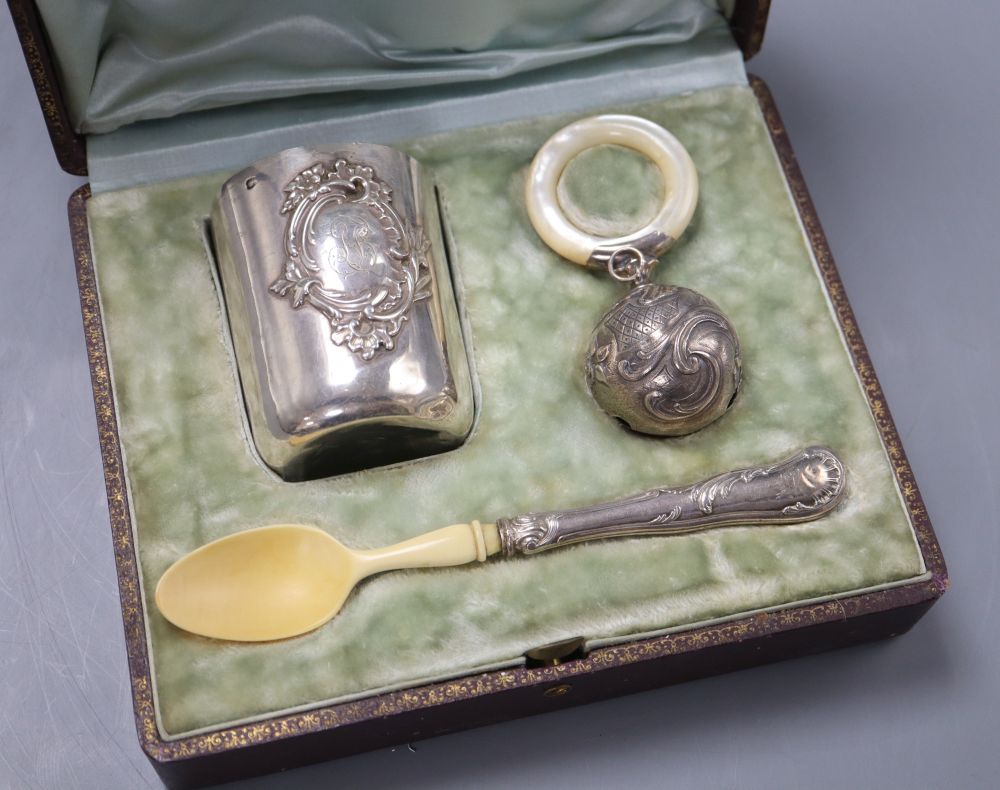 A French white metal christening set comprising tumbler, rattle and ivory bowl and spoon, c.1900, in original fitted case